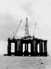 Looking up at a petroleum drillship (or “rig”), viewed from a distance